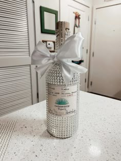 a bottle with a bow on it sitting on a counter