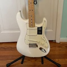 an electric guitar sitting on top of a stand