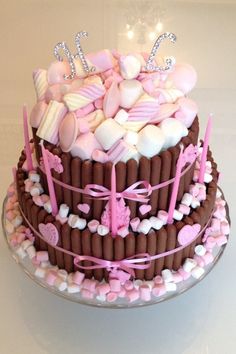 a chocolate cake decorated with marshmallows and hearts