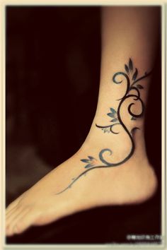 a woman's foot with an artistic tattoo design on the top and bottom of it