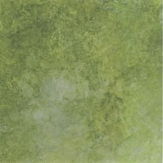 an image of a green surface with some dirt on it's sides and the top part of the floor visible