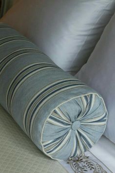 a close up of a pillow on a bed