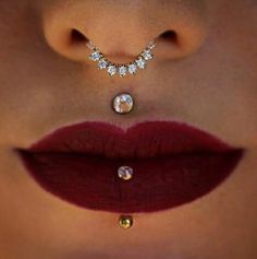 a woman's lips and nose piercings are shown with diamonds on the lip