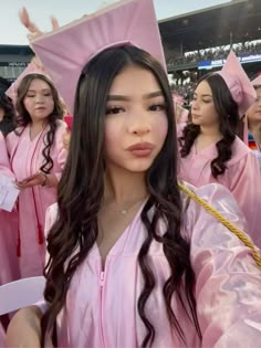 a group of women in pink graduation gowns