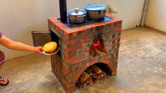 a woman holding a plate with food in front of a brick oven