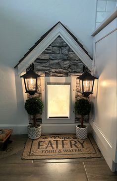 a front door with lanterns and potted plants