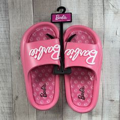 Barbie Women's Mattel Beach Slides Sandals Slip-On Logo Pink Size 6 New With Tag. Sandals In Photos Are The Exact One You Are Purchasing. Please Examine The Photos Entirely As They Are Part Of The Details. -Size: 6 -Color: Pink -Slip-On -Rubber Outsole Due To Variations In Phone Displays Or Computer Monitor Settings And The Light Brightness When Taking Photos, The Real Color Of The Item May Be Slightly Different From The Photos Shown. Message Me If You Have Any Questions! All Items Are Shipped T Pink Round Toe Slippers For Summer, Pink Open Toe Slippers For Summer, Summer Pink Open Toe Slippers, Summer Open Toe Pink Slippers, Fun Vacation Slides, Non-slip Round Toe Flip Flops For Beach Season, Closed Toe Synthetic Sport Sandals For Beach, Synthetic Closed Toe Sport Sandals For Beach, Pink Summer Slip-on Slides