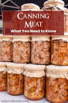 jars filled with food sitting on top of a table next to a sign that says canning meat what you need to know