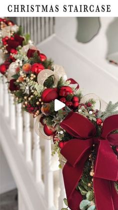 a christmas garland on the banister with red bows