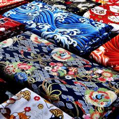 many different colored ties are laid out on the table together and ready to be sold