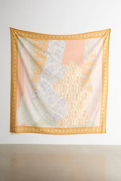 an orange and white tapestry hanging on the wall