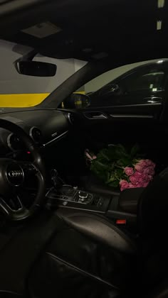 the interior of a car with flowers on the dashboard