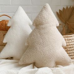 two white pillows sitting on top of a bed