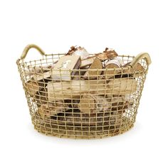 a wire basket filled with logs on top of a white surface