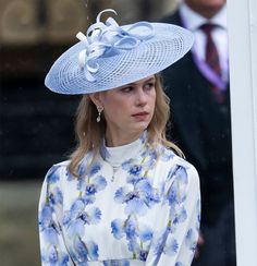 a woman wearing a blue hat and dress