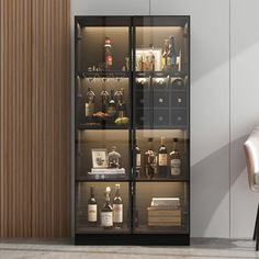 a glass door cabinet filled with bottles and wine glasses next to a white dining room chair