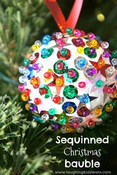 an ornament hanging from a christmas tree with the words sequinned christmas bauble on it