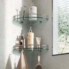 a bathroom with two shelves holding various items