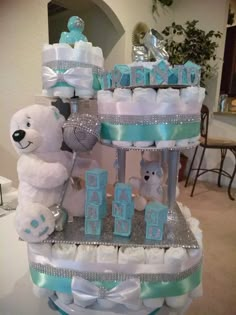 a diaper cake that has teddy bears on it and is decorated in blue and white