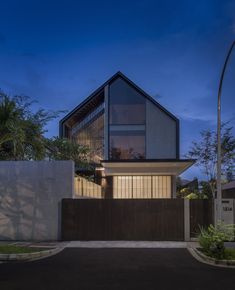 a modern house is lit up at night