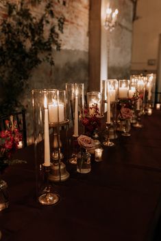 a long table with candles and flowers on it