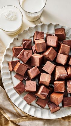 a white plate topped with pieces of chocolate