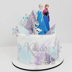 there is a cake decorated with frozen princess figures