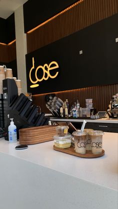 a counter with coffee cups and saucers on it next to a sign that says dole