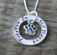 a dog's paw is shown in the center of this necklace