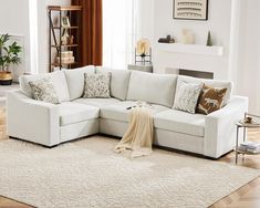 a living room with a sectional couch and pillows