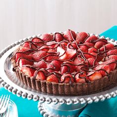 there is a chocolate cake with strawberries on it