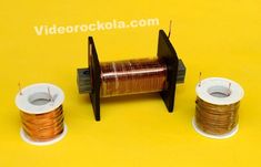 two spools of wire sitting next to each other on a yellow table top