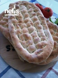 two homemade breads sitting on top of a cutting board