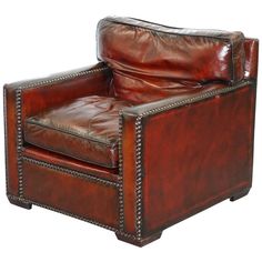 a brown leather chair with studded trimmings