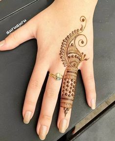 a woman's hand with a henna tattoo on it