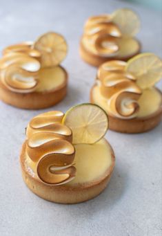 lemon custard tarts on top of each other with a slice of lime in the middle