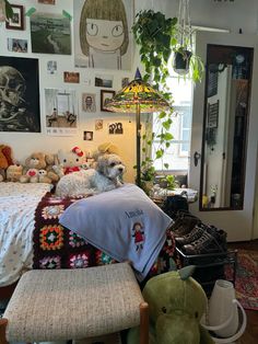 a bedroom with stuffed animals and pictures on the wall