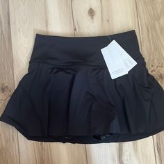 Brand New Never Worn Black Athleta Tennis Skort Fitted Black Skort For Sports, Sporty Stretch Black Tennis Skirt, Sporty Black Stretch Tennis Skirt, Black Stretch Skort For Sports, Sporty Black Tennis Skirt With Elastic Waistband, Sporty Black Skort For Sports, Black Short Tennis Skirt For Athleisure, Black Short Swim Skirt For Workout, Black Sports Skort For Summer