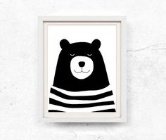 a black and white bear in a hat on a wall with the words buy one get two