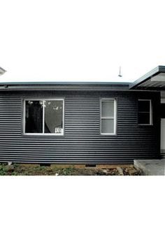 a black house with white trim and windows