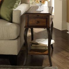 a living room scene with focus on the end table and sofa in the foreground