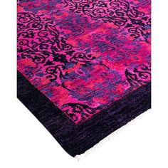 a pink and purple rug with an intricate design on the bottom, in front of a white background