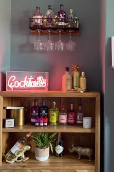 a shelf with liquor bottles and glasses on it