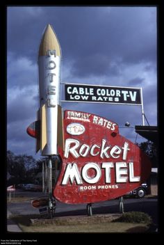 an old rocket motel sign is shown in front of a cloudy sky