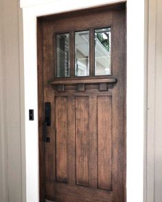 a wooden door with glass on the side