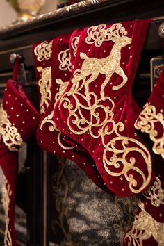 a red and gold christmas stocking hanging from a fireplace