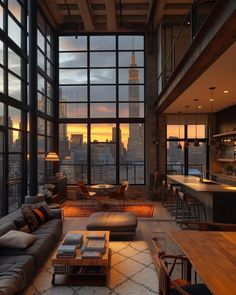 a living room filled with lots of furniture and tall buildings in the background at sunset