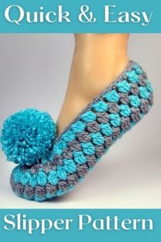 a pair of slippers with a pom - pom on top