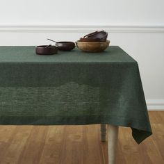 a green table cloth with two bowls on it