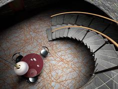 an aerial view of a spiral staircase with two balls on the floor and one ball in the middle